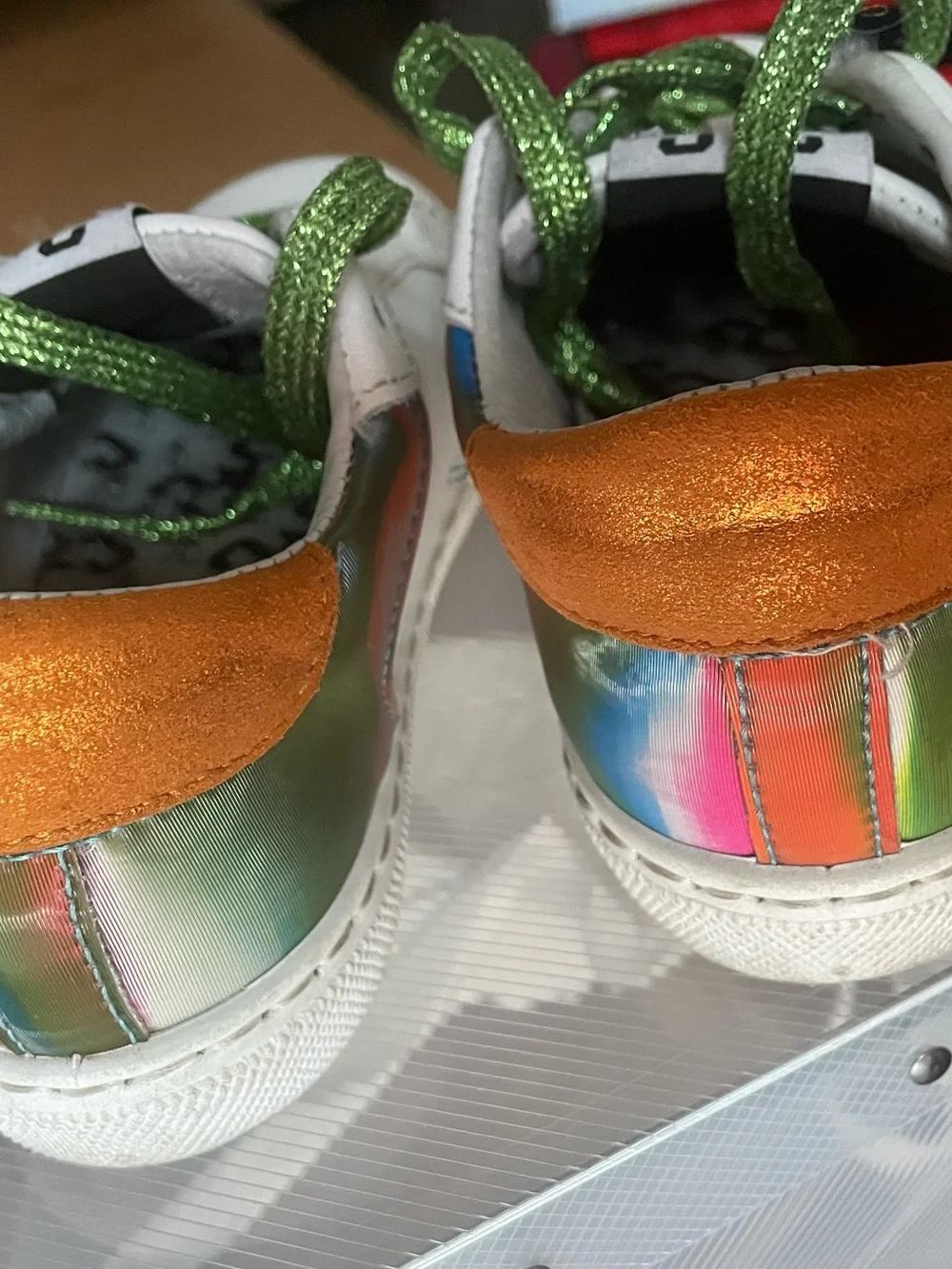 Kids White Sneakers with Orange Star Accents and Green Glitter Laces